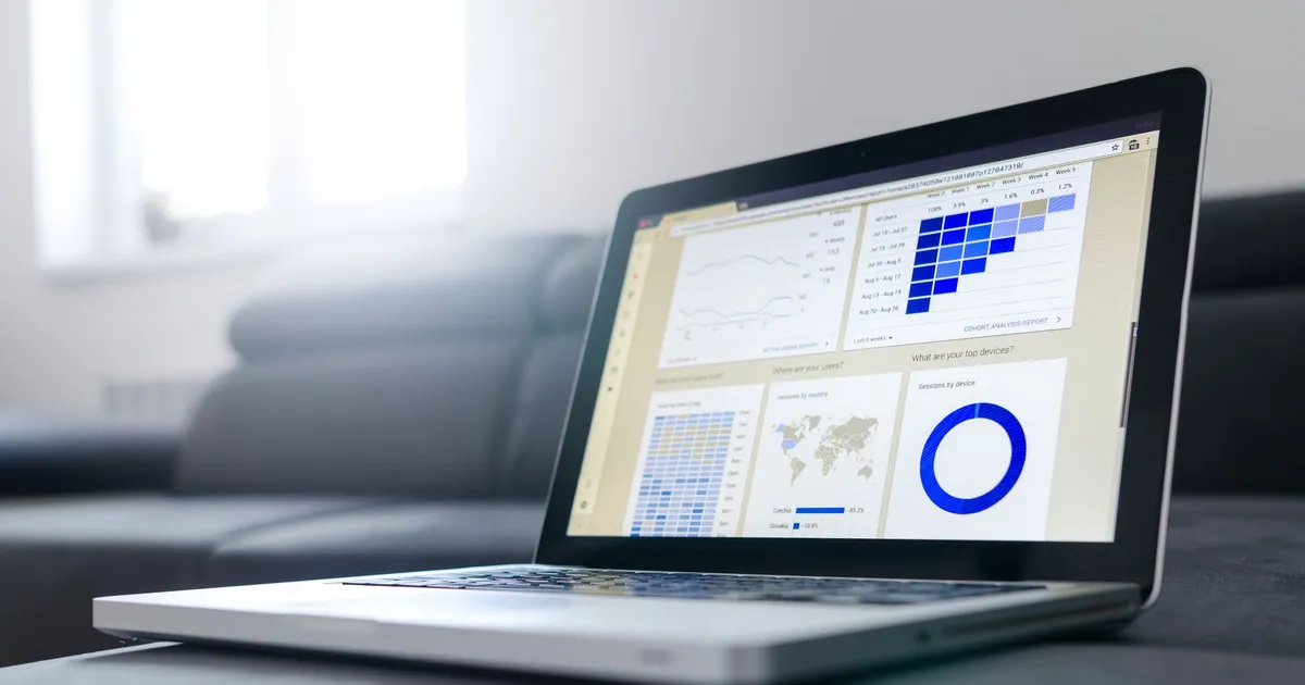 Sleek laptop showcasing data analytics and graphs on the screen in a bright room.