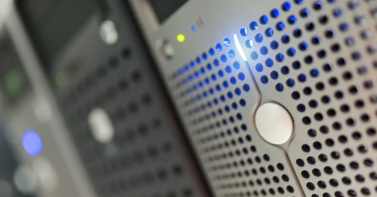 Focused detail of a modern server rack with blue LED indicators in a data center.