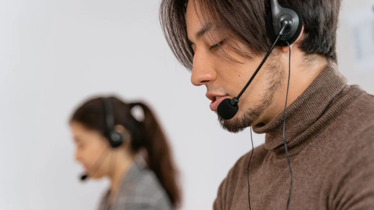 Focused call center employees wearing headsets, assisting customers with exceptional service.